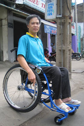 Photo of a man in Vietnam using a RoughRider wheelchair designed by Whirlwind Wheelchair