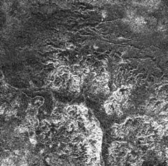 Black and white radar image showing fluvial systems and river canyons on the surface of Titan.