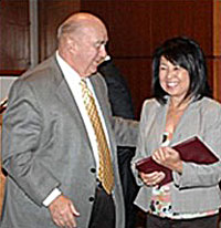 Photo of California State University Chancellor Charles B. Reed, presenting an honorary degree certificate to Vivian Uwate Nelson, daughter of Aiko Nishi Uwate.