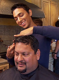 A photo from the film showing a father having his hair cut by his gay son.