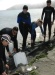A photo of students nudging a bat ray back into the water.