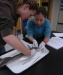 A photo of Lindsey Sauer and Natsumi Iwata making the first incision on a spiny dogfish.