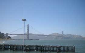 Photo of a radar transmitter located at Crissy Field in San Francisco, with the bay and the Golden Gate Bridge in the background. 